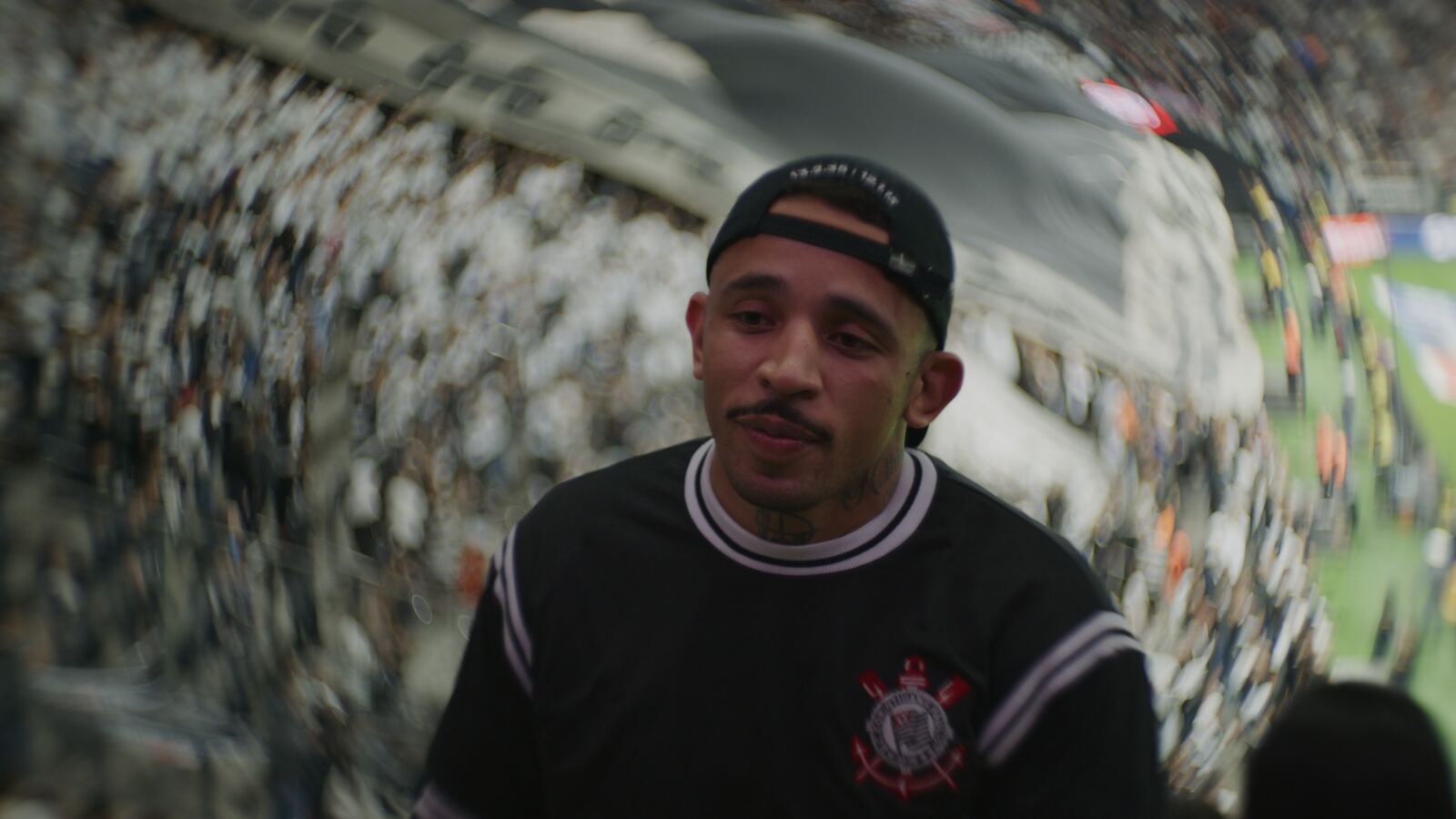 Carlos Prates in the stands, framed by the swirling bokeh of the Petzval lens