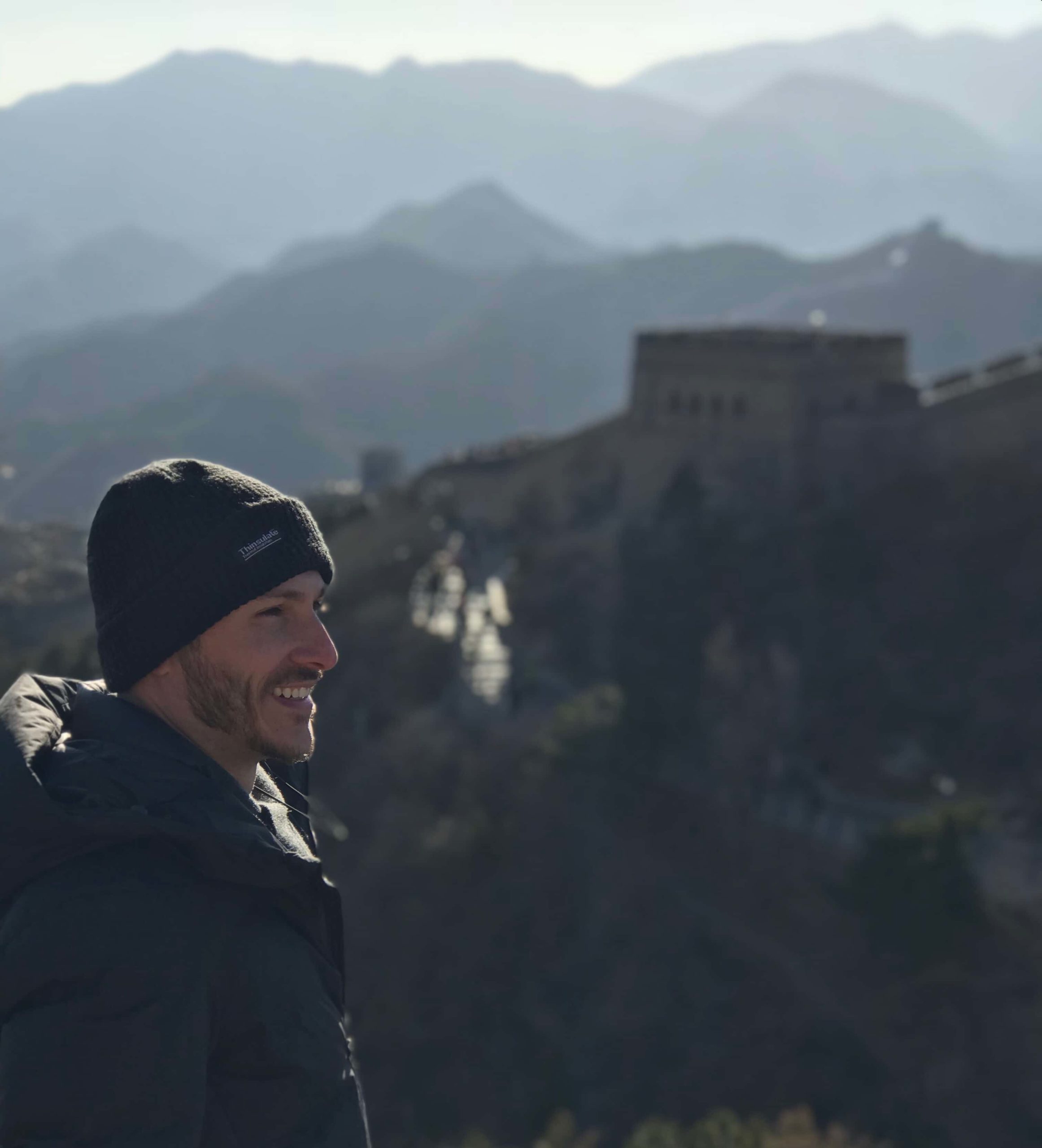 man uses hood on the Great Wall of china cold winter